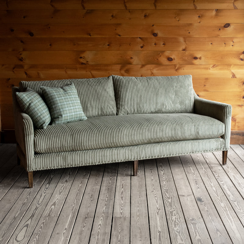 Muted Green Corded Velour Bench Seat Cushion Sofa with Plaid Throw Pillows, Angled Front View