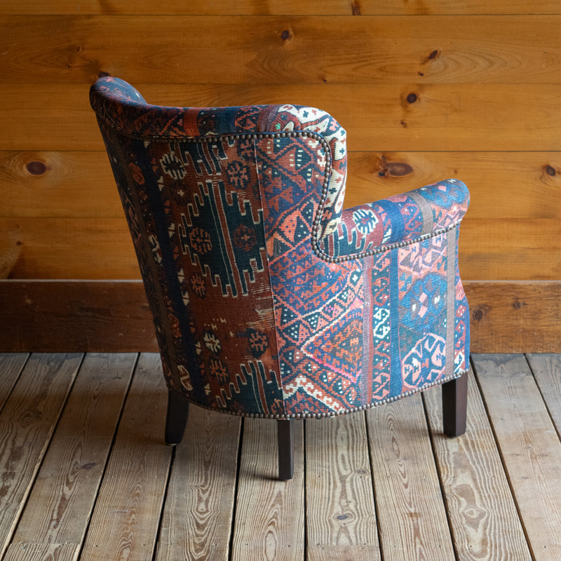 Petite Tightback Armchair Upholstered in Blue, Red, and Pink Abstract Kilim Fabric, Angled Side View