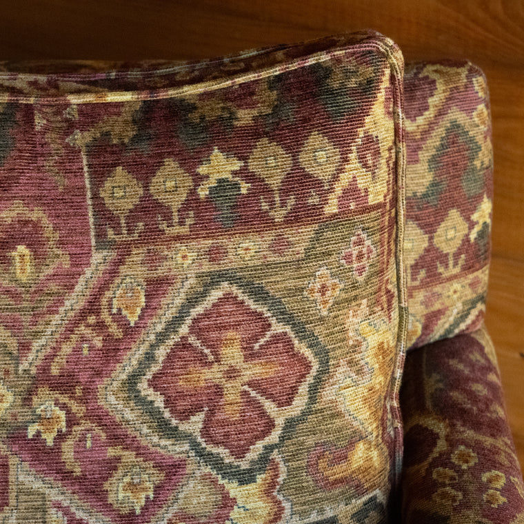 Rustic Track Arm Chair Upholstered in Rust, Plum, and Gold Tone Fabric Inspired by Antique Carpets, Angled Back View